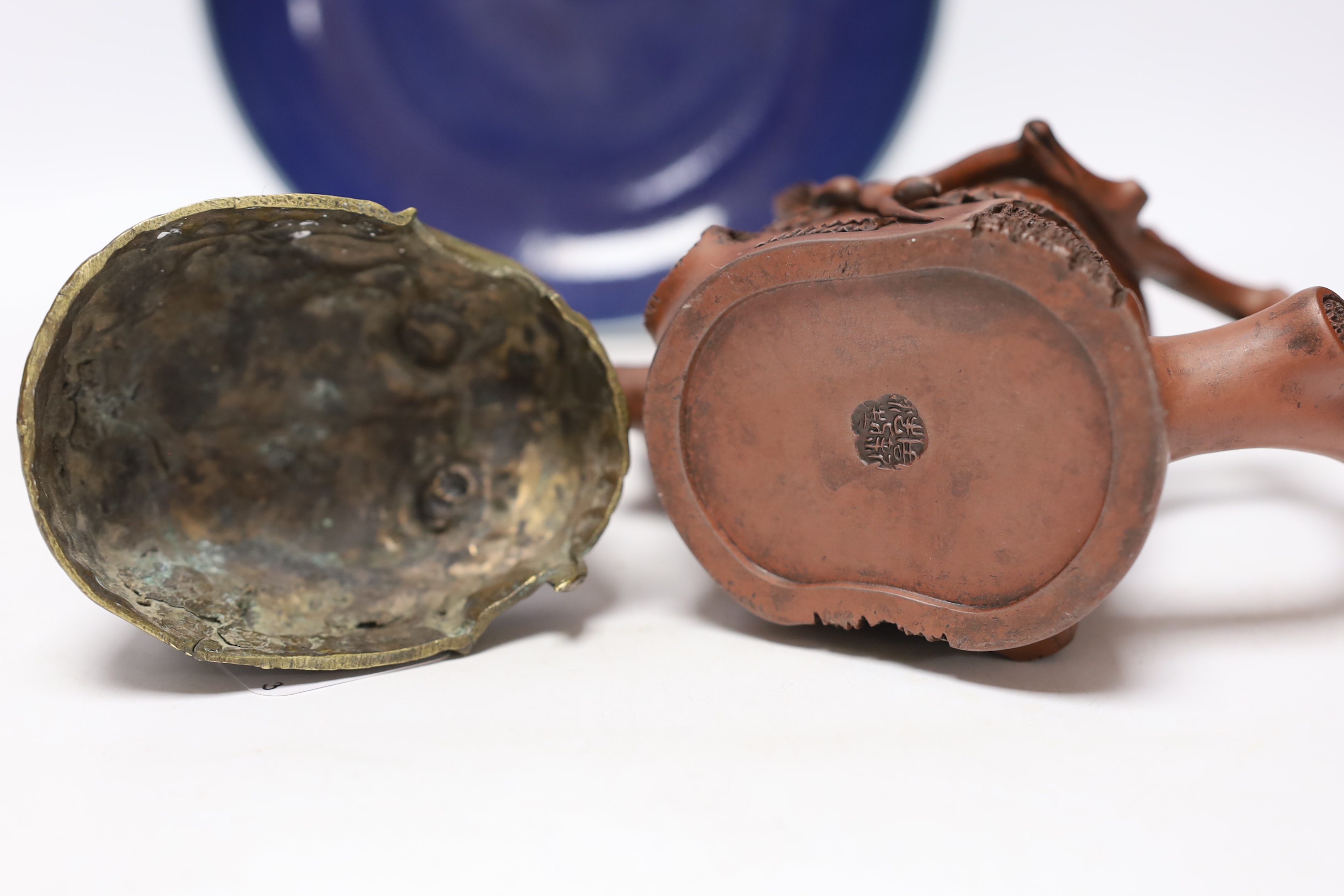 A Chinese Yixing ‘tree branch’ teapot, 13cm, A 20th century Tibetan kapala cover, 9cm and a Chinese blue glazed dish, Yongzheng mark but later, 22.5cm diameter